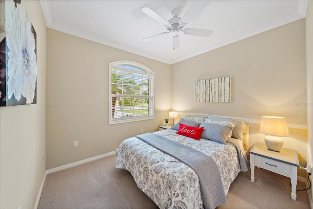 bedroom featuring baseboards, carpet floors, ornamental molding, and a ceiling fan