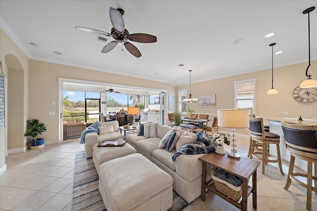 living room with plenty of natural light, light tile patterned flooring, and ornamental molding