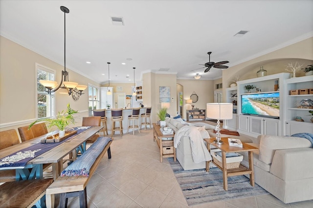 living area featuring crown molding, built in shelves, visible vents, and light tile patterned floors