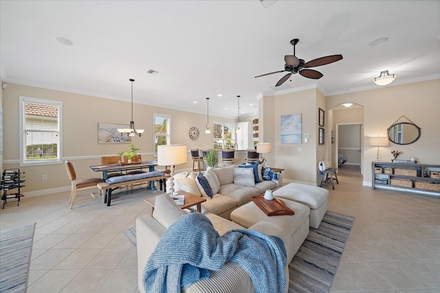 living room featuring crown molding, light tile patterned floors, and ceiling fan with notable chandelier