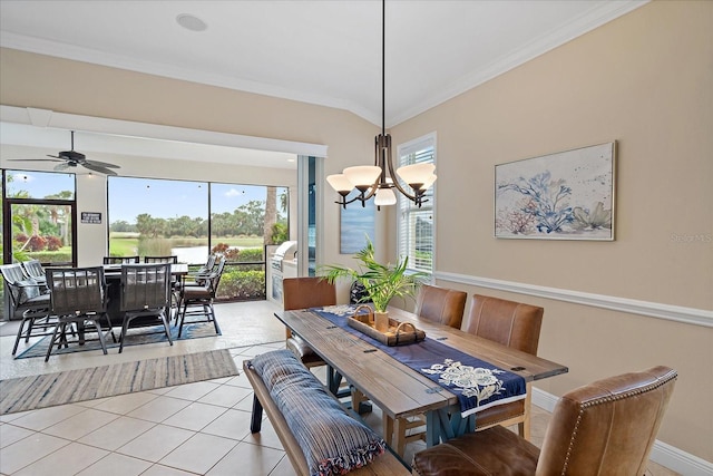 dining area featuring ceiling fan with notable chandelier, plenty of natural light, crown molding, and light tile patterned flooring