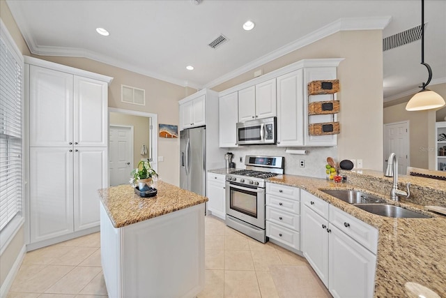 kitchen featuring visible vents, ornamental molding, stainless steel appliances, and a sink