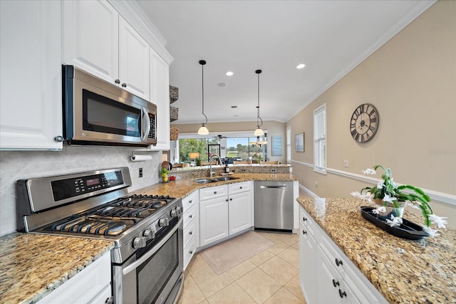 kitchen featuring white cabinetry, sink, hanging light fixtures, light tile patterned floors, and appliances with stainless steel finishes