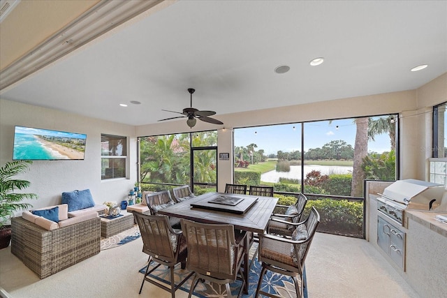 sunroom featuring ceiling fan