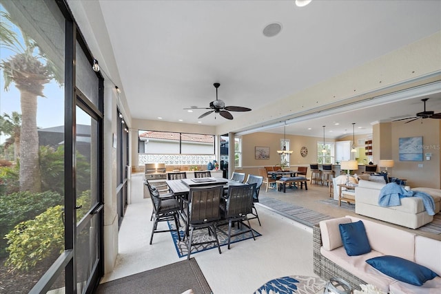 sunroom featuring ceiling fan