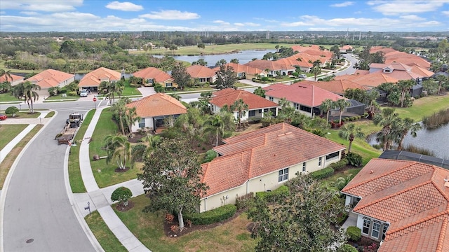 birds eye view of property with a residential view and a water view