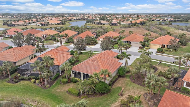 drone / aerial view featuring a residential view and a water view