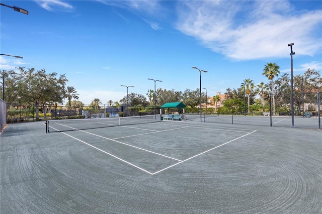 view of tennis court with fence