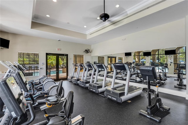 gym featuring a raised ceiling, crown molding, and french doors