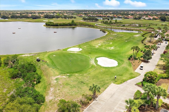 bird's eye view with view of golf course and a water view