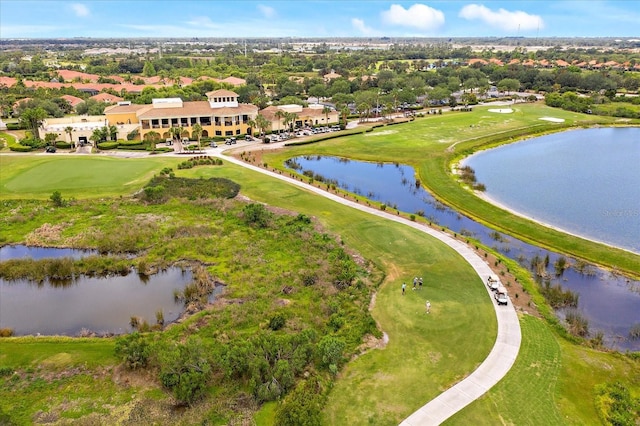 birds eye view of property with view of golf course and a water view