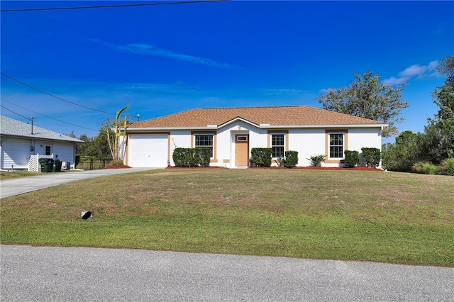 ranch-style house featuring a front lawn and a garage