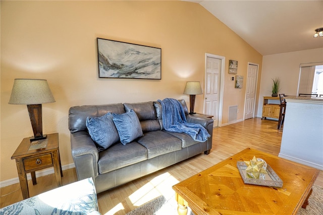 living room featuring hardwood / wood-style floors and lofted ceiling