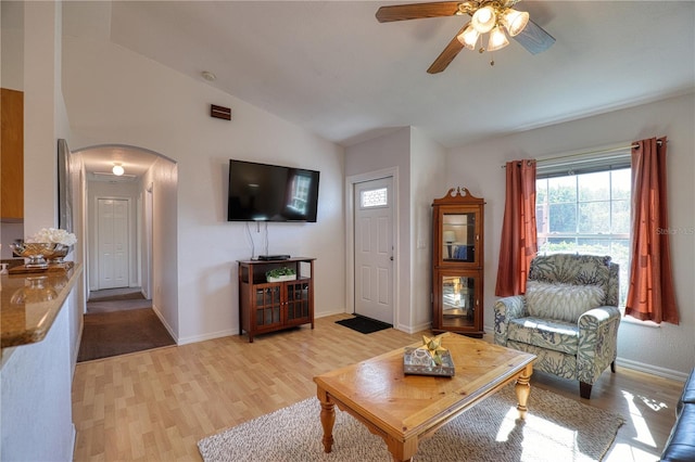 living room featuring ceiling fan, light hardwood / wood-style floors, and lofted ceiling