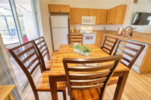 kitchen with white appliances, light hardwood / wood-style floors, and sink