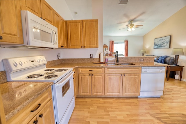 kitchen with kitchen peninsula, white appliances, ceiling fan, sink, and light hardwood / wood-style floors