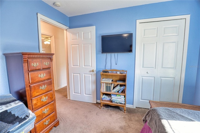 carpeted bedroom featuring a closet