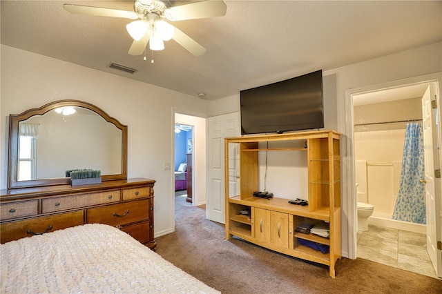 carpeted bedroom with ceiling fan, a textured ceiling, and connected bathroom