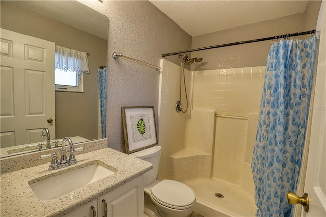 bathroom featuring vanity, curtained shower, toilet, and a textured ceiling