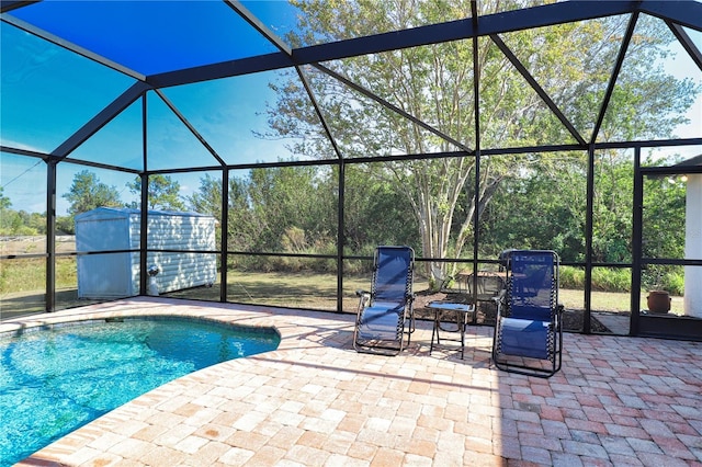 view of swimming pool featuring glass enclosure and a patio