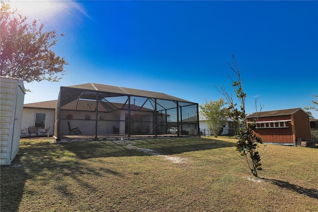 view of yard featuring a lanai and a storage shed