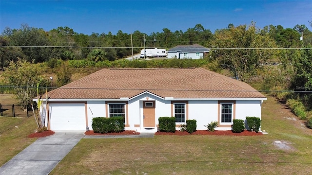 view of front of house featuring a garage and a front lawn