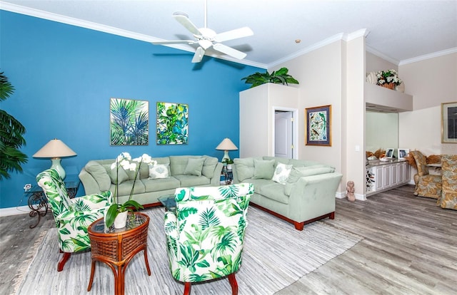 living room with ceiling fan, hardwood / wood-style floors, and ornamental molding