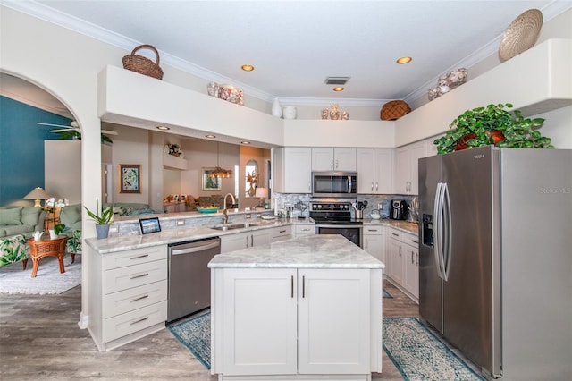 kitchen featuring kitchen peninsula, sink, white cabinets, and appliances with stainless steel finishes