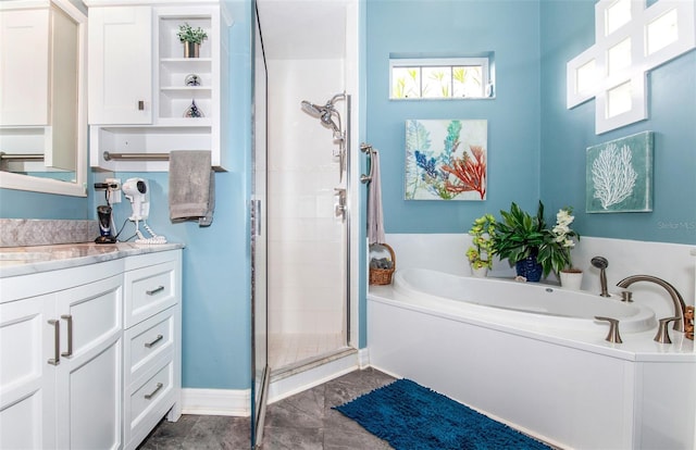 bathroom with vanity and independent shower and bath