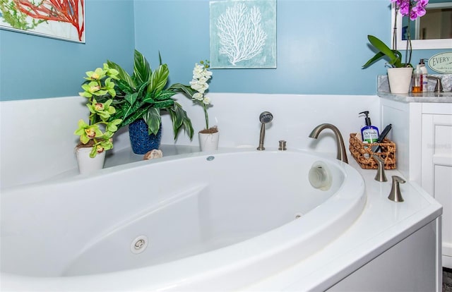 bathroom with vanity and a bath