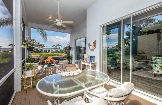 sunroom featuring ceiling fan