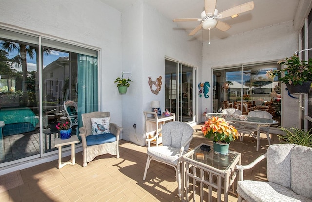 sunroom featuring ceiling fan