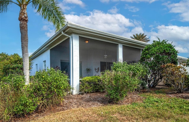 view of property exterior with a sunroom