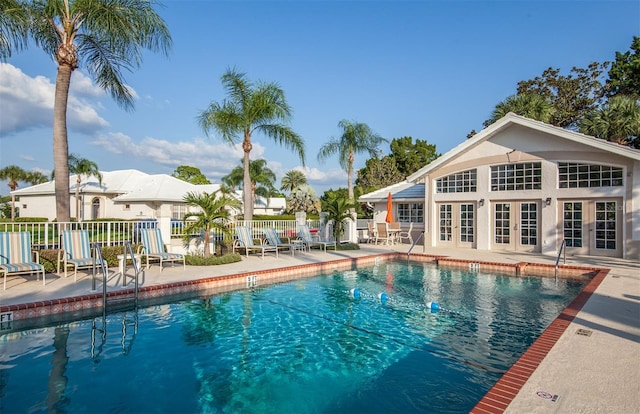 view of swimming pool with a patio area and french doors