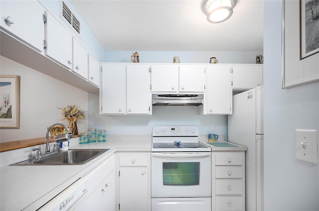 kitchen featuring white cabinetry, sink, and white appliances