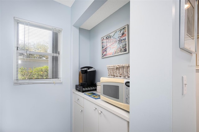 interior space featuring a healthy amount of sunlight and white cabinetry