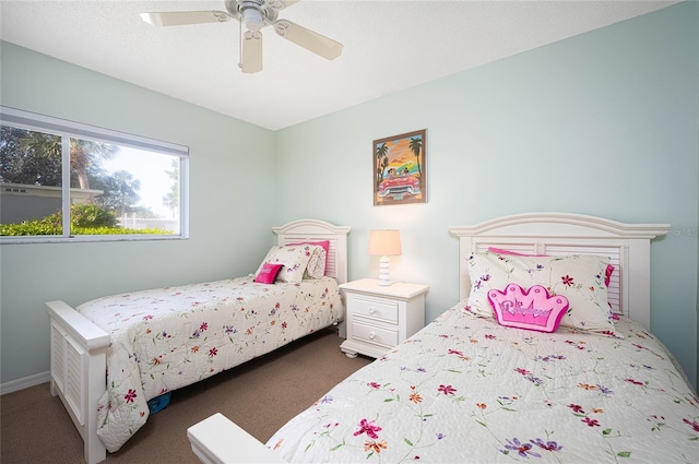 bedroom featuring dark colored carpet and ceiling fan