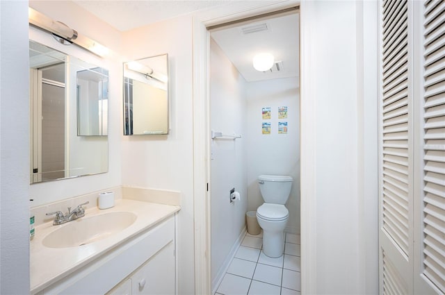 bathroom with tile patterned floors, a shower, vanity, and toilet