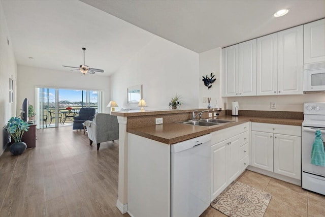 kitchen featuring sink, white cabinetry, white appliances, ceiling fan, and kitchen peninsula