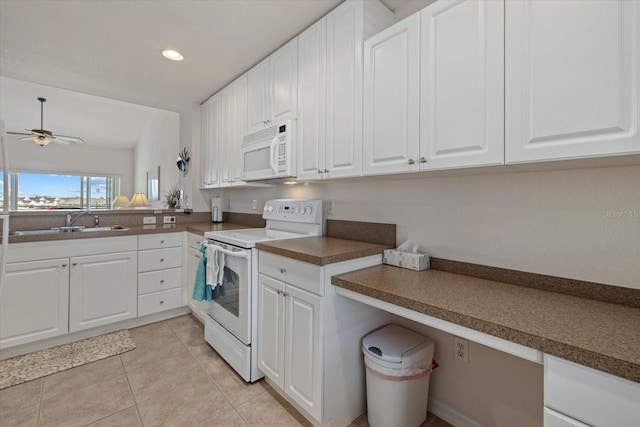 kitchen featuring sink, white appliances, white cabinetry, and light tile patterned flooring