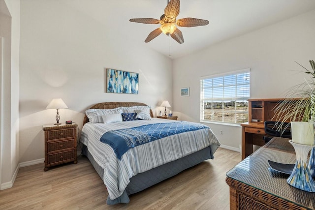 bedroom with lofted ceiling, ceiling fan, and light hardwood / wood-style flooring