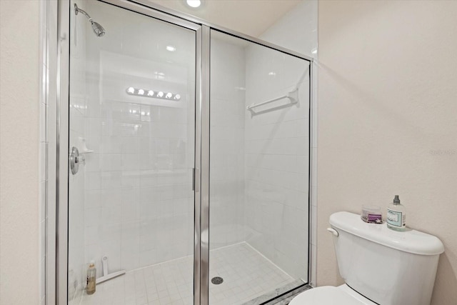 bathroom with walk in shower and toilet