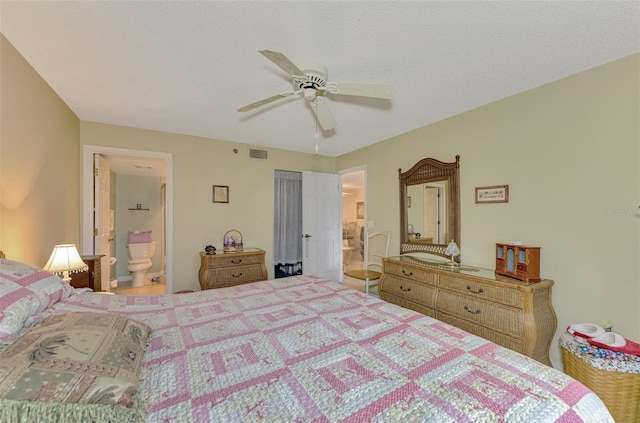 bedroom with connected bathroom, ceiling fan, and a textured ceiling