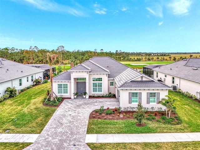 view of front of home with central AC unit and a front yard