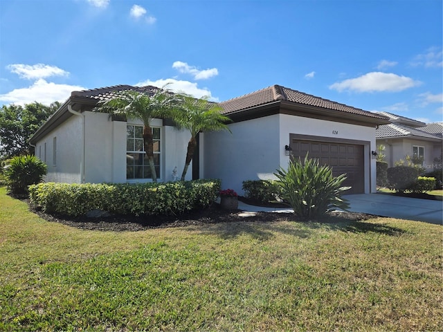 view of front facade with a garage and a front lawn