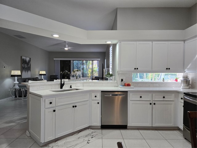 kitchen with white cabinets, sink, ceiling fan, appliances with stainless steel finishes, and kitchen peninsula