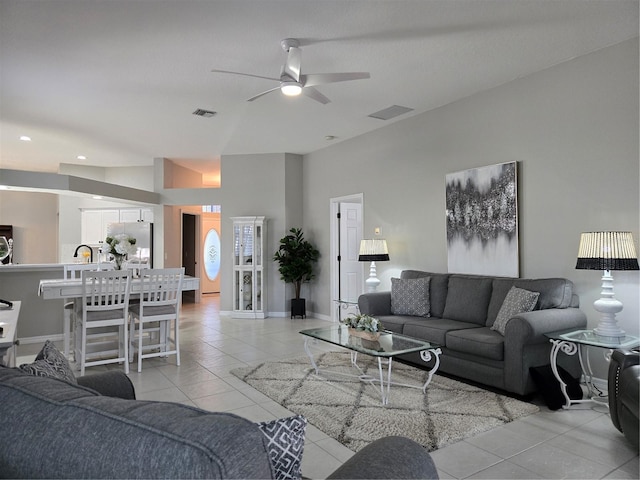 living room with light tile patterned floors, ceiling fan, and lofted ceiling