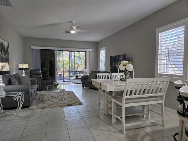 dining space featuring ceiling fan and light tile patterned floors