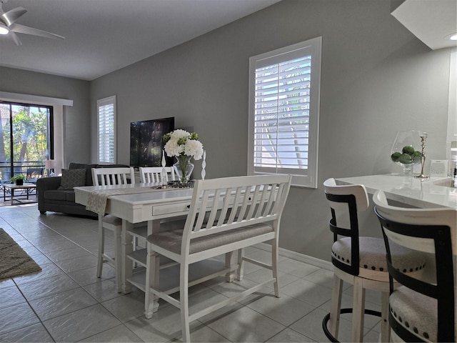 tiled dining area with ceiling fan