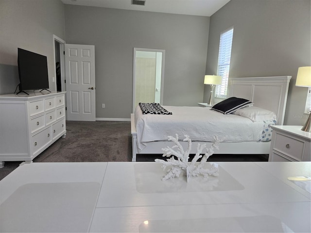 bedroom featuring dark colored carpet